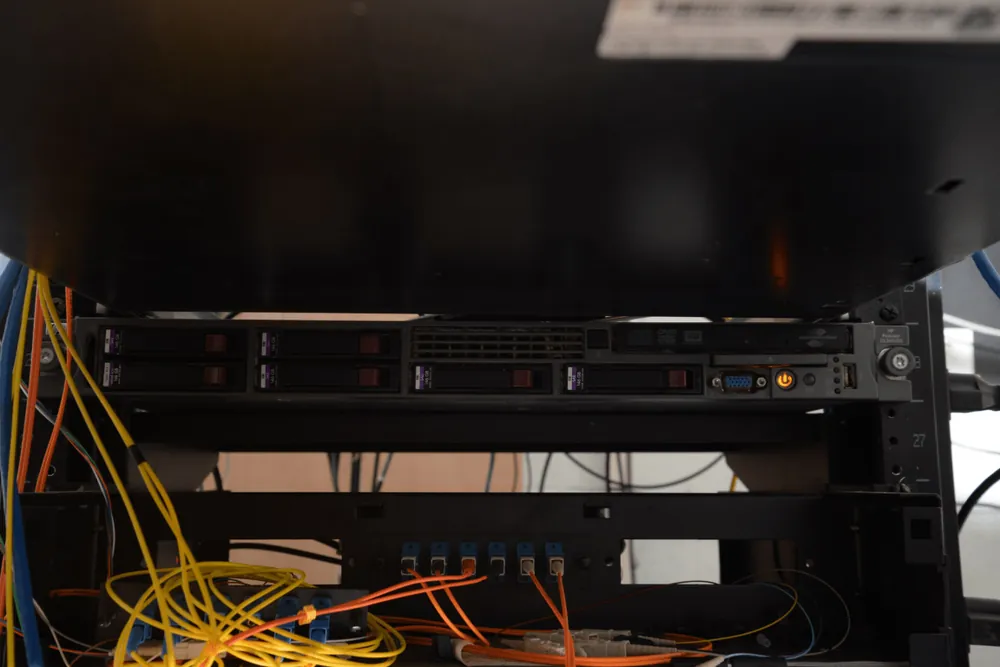 Server rack with hard drives and network cabling in a data centre